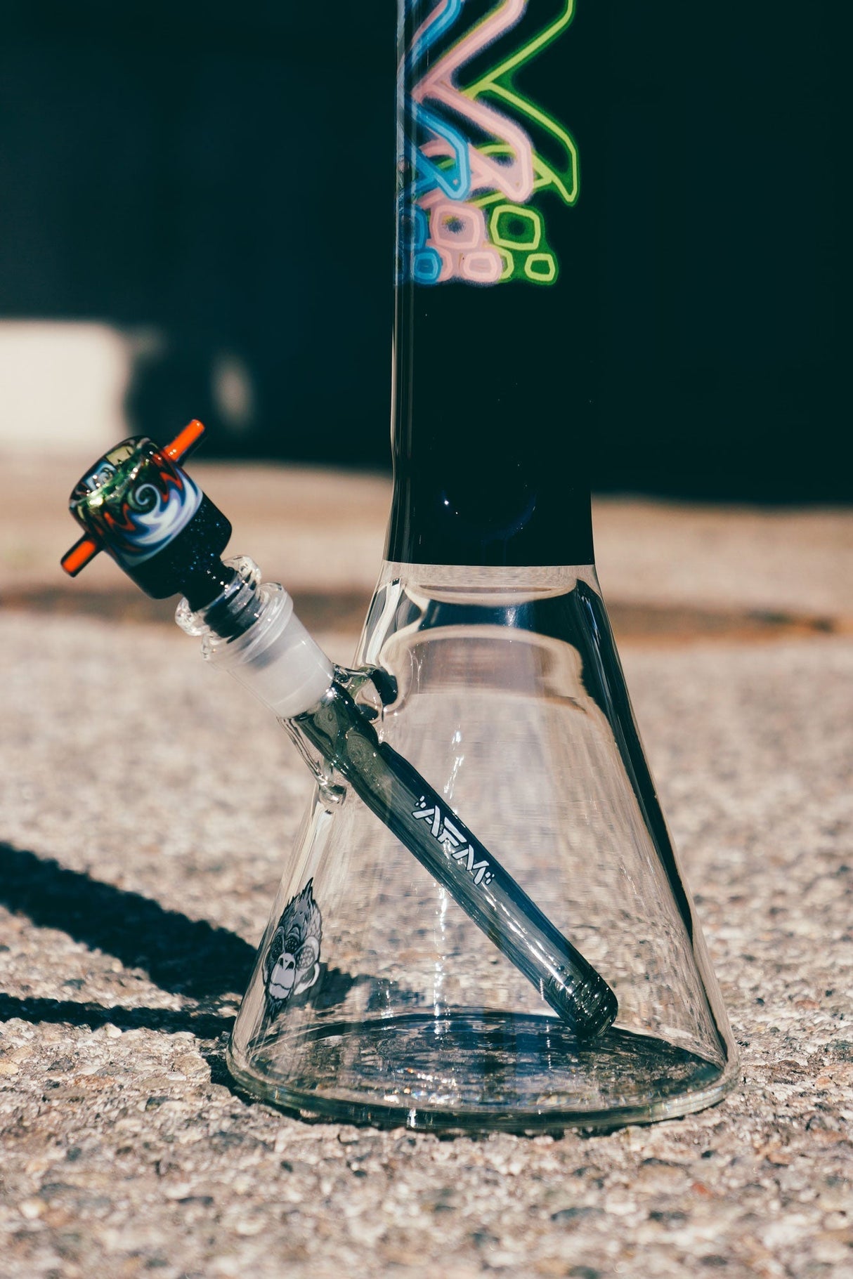 AFM The Trippy Neon Beaker Set, 18" Borosilicate Glass Bong for Dry Herbs, Side View on Concrete