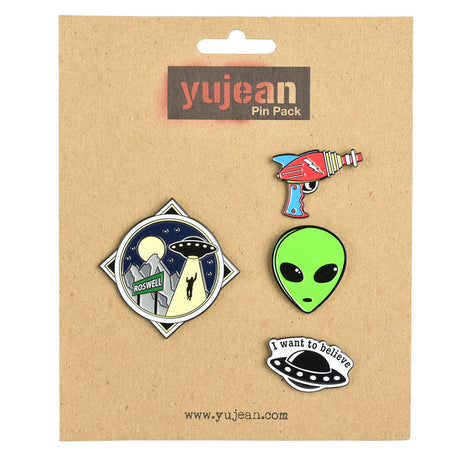 Alien Enamel Pin Pack of 4 with UFO, Roswell, Ray Gun, and Alien Face Designs on Cardboard