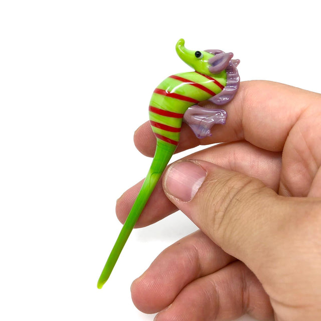 AFM Seahorse Glass Dabber Tool in hand, striped design with purple accents, for dab rigs