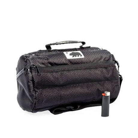 Cali Crusher Cali Duffle 12" Standard in black, front view, with durable fabric and zipper, next to lighter for scale