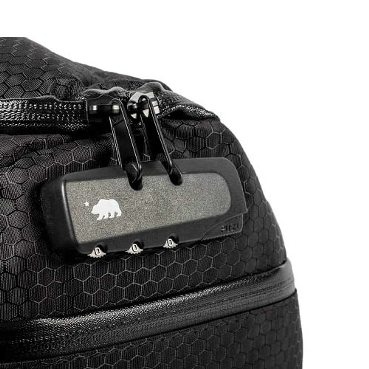 Close-up of Cali Duffle® 16" Standard's silicone tag on black textured bag by Cali Crusher