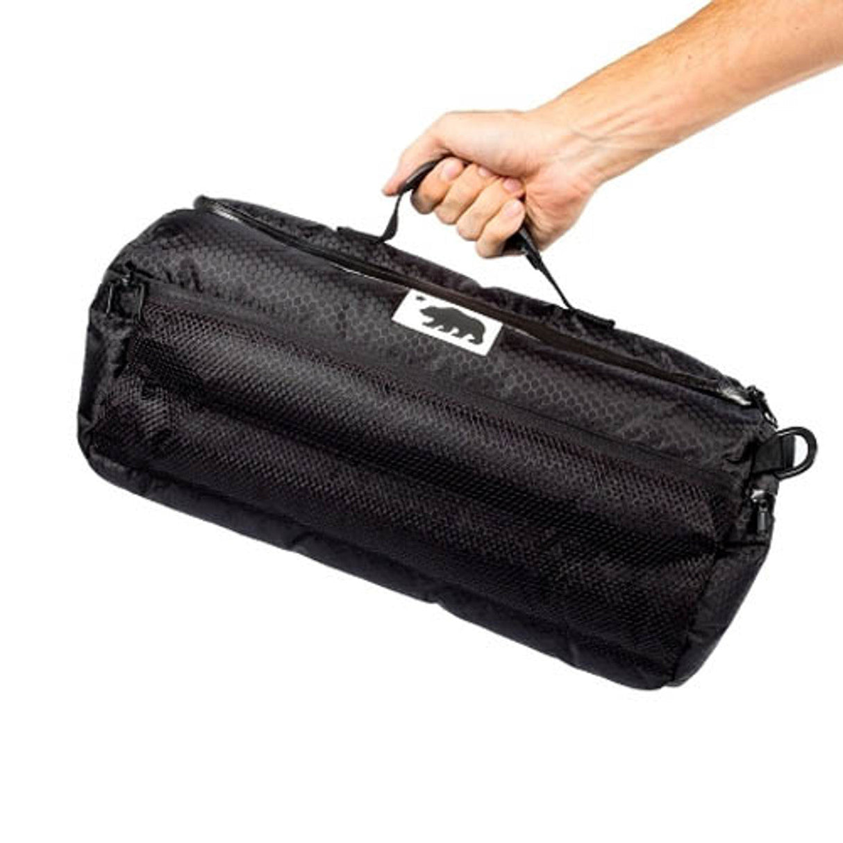 Cali Duffle 16" Standard by Cali Crusher, black silicone duffel bag, held in hand, side view