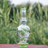 Calibear Ball Rig Carta Attachment in clear glass with green accents, front view on natural background