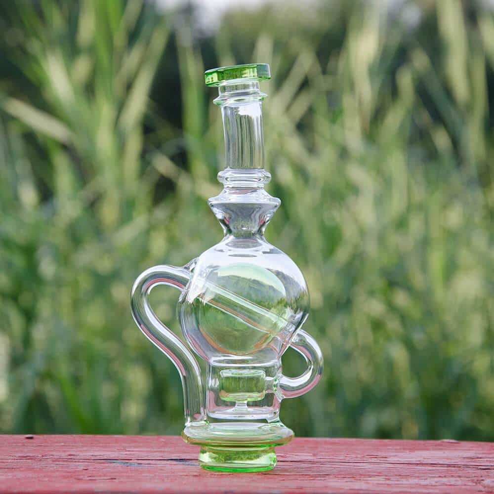 Calibear Ball Rig Carta Attachment in clear glass with green accents, outdoor side view