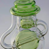 Close-up of Calibear Ball Rig Carta Attachment in clear glass with green accents, designed for vaporizers