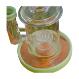 Calibear Mini Can Dab Rig in green, close-up side view, with intricate glasswork on 14mm joint