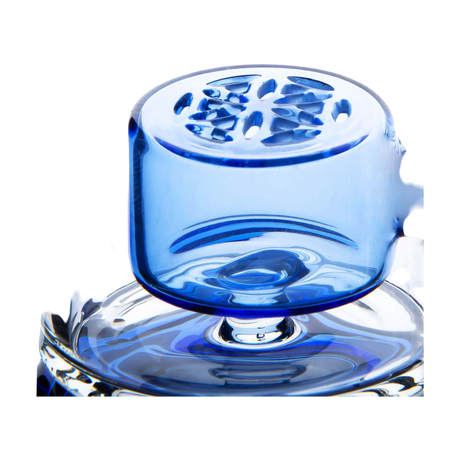 Calibear Puffco Attachment Klein in blue, close-up side view on clear glass