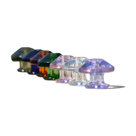Calibear Puffco Peak Carb Cap set in various colors displayed on outdoor surface