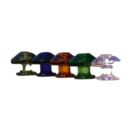 Assorted Calibear Puffco Peak Carb Caps in various colors displayed on outdoor ledge