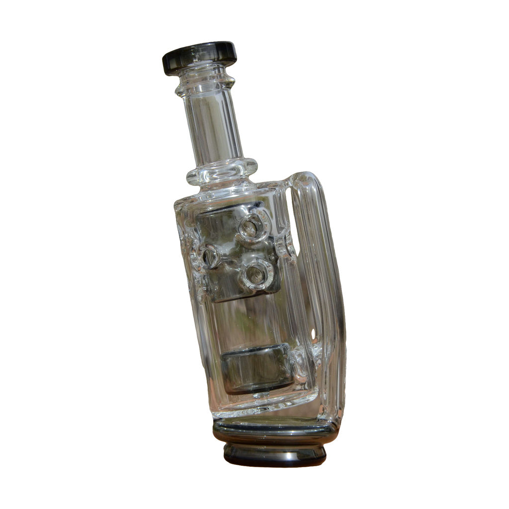 Calibear Straight Fab Puffco Attachment in clear glass, side view on natural background