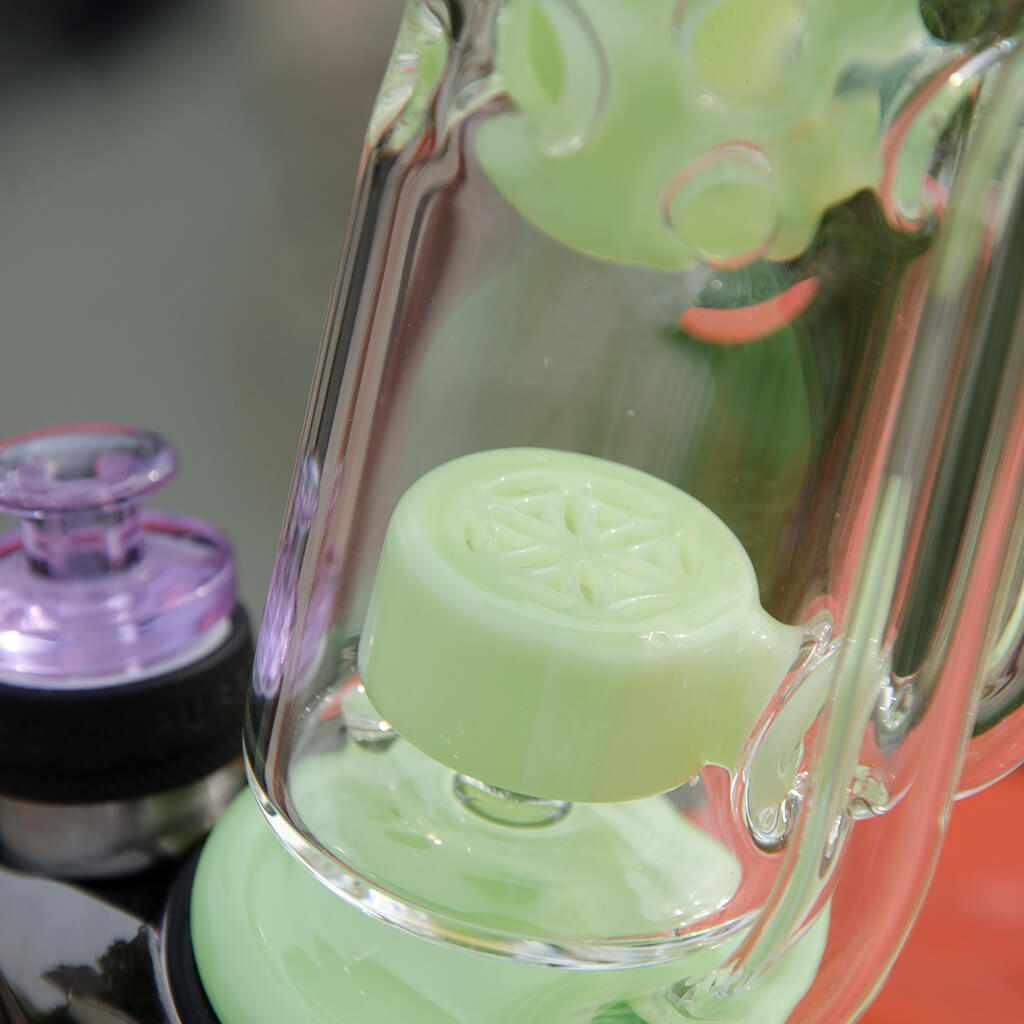 Close-up of Calibear Straight Fab Puffco Attachment in green, showcasing intricate glasswork