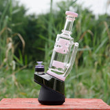 Calibear Straight Fab Puffco Attachment in pink on e-rig, outdoor view on wooden surface