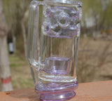 Calibear Straight Fab Puffco Attachment in clear and purple, outdoor side view on wooden ledge