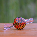 Calibear Wigwag Bubble Carb Cap in high-quality borosilicate glass, side view on wooden surface