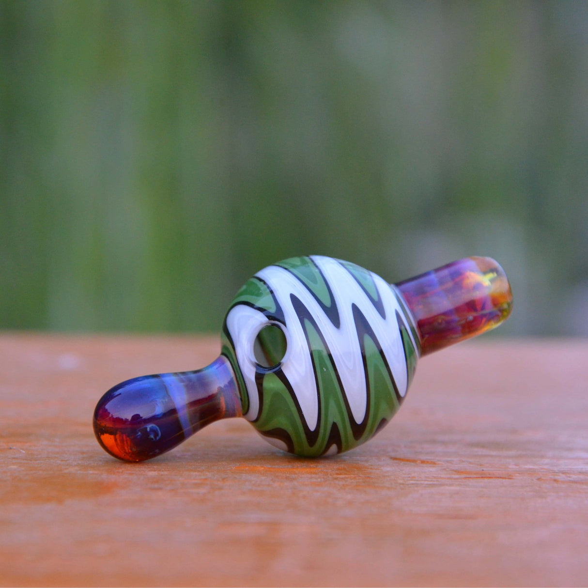 Calibear Wigwag Bubble Carb Cap made of Borosilicate Glass, Side View on Wooden Surface
