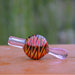 Calibear Wigwag Bubble Carb Cap in Red, High-Quality Borosilicate Glass, Side View on Wooden Surface