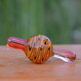 Calibear Wigwag Bubble Carb Cap in yellow, high-quality borosilicate glass, angled side view on wooden surface