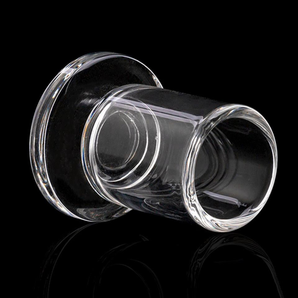 The Stash Shack Carb Cap Holder, clear glass, angled view on reflective surface, for dab rig organization