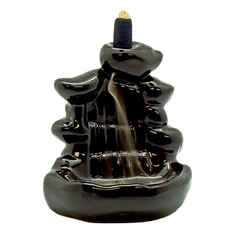 Cascade Steps Ceramic Backflow Incense Burner at 4.5" height, front view with lit incense cone