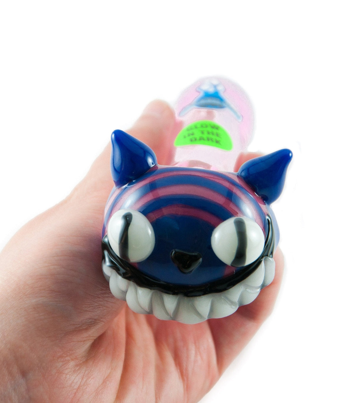 Chameleon Glass Cheshire Cat Pipe with glow-in-the-dark feature, held in hand to show size