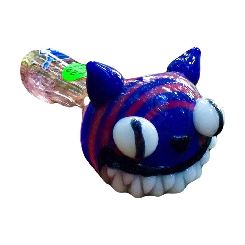 Chameleon Glass - Cheshire Cat themed glow-in-the-dark pipe in forest setting
