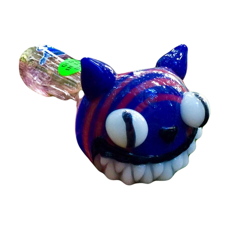 Chameleon Glass - Cheshire Cat themed glow-in-the-dark pipe in forest setting