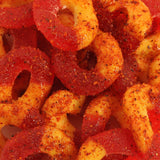 Close-up of Chilli Bomba Spicy Peach Rings 8oz with tangy sugar coating