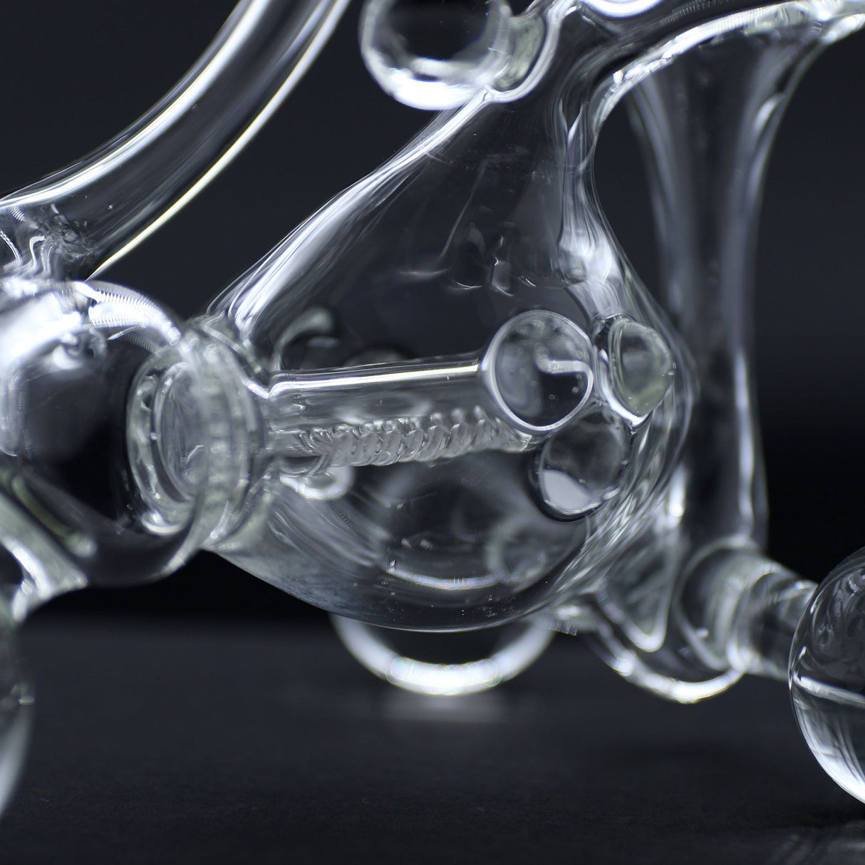Close-up of Clayball Glass "Translucent Dreams" Heady Recycler Dab-Rig on black background