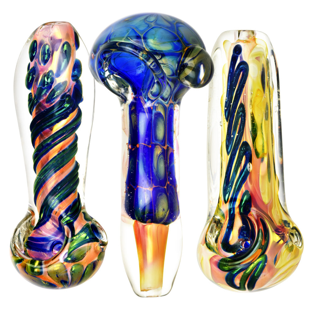 Fumed Glass Spoon Pipes in various colors with intricate designs, front view on white background
