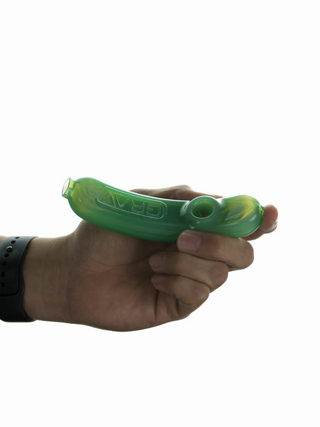 Hand holding GRAV Rocker Steamroller in green, compact borosilicate glass pipe for dry herbs