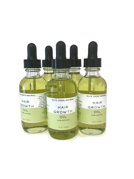 Elite Creed Natural Hair Growth Oil with CBD, front view of three bottles on white background