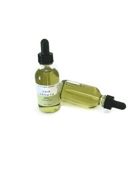 Elite Creed Natural CBD Hair Growth Oil in clear dropper bottles - front and side view