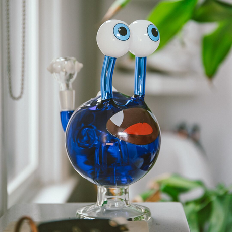Hemper Globgoblin Monster Bong in blue with cartoonish eyes, 8.5" tall, front view on a natural background