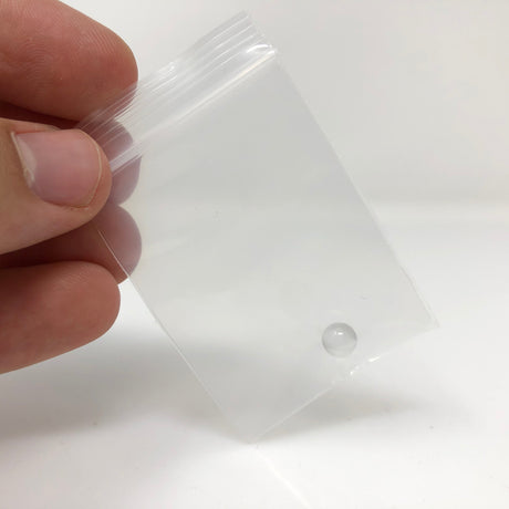 AFM Quartz Glass Banger Insert held in hand, clear view of round quartz bucket insert