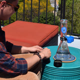 SnowTree 9MM Beaker Bong with 14mm bowl, outdoor setting on a sunny day