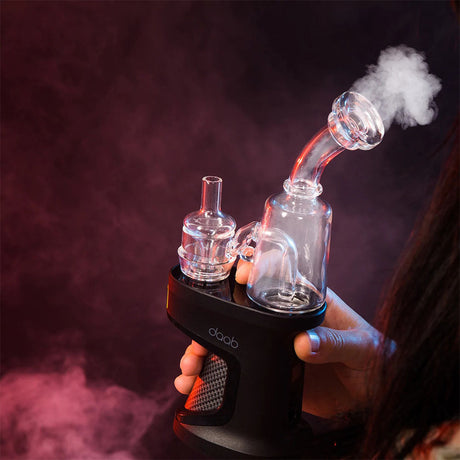 Ispire daab Induction eRig Kit in use with visible vapor, showcasing its sleek design and portability