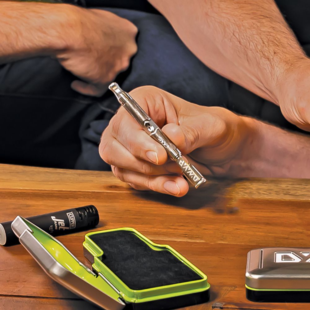 DynaVap The M 7 XL vaporizer lifestyle photograph showing the device on a plain surface, angle one.