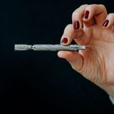 DynaVap The M 7 XL vaporizer lifestyle photograph showing the device on a plain surface, angle two.