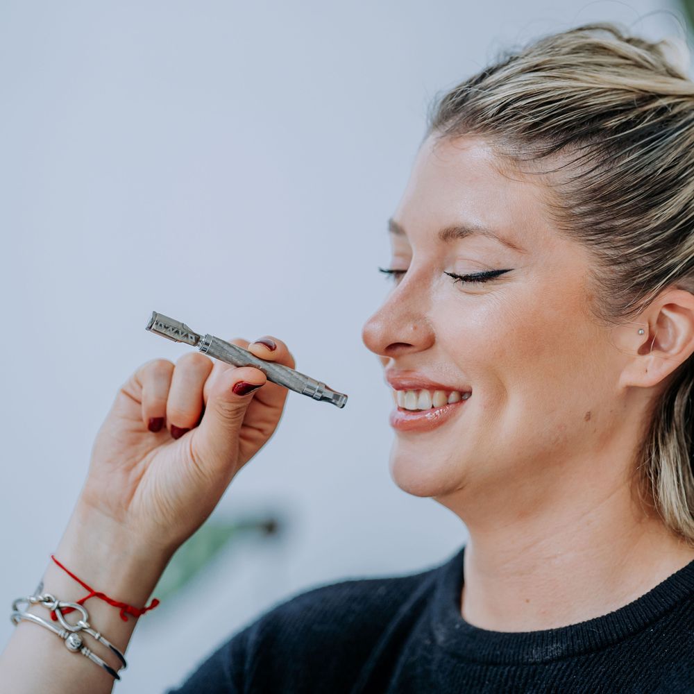 DynaVap The M 7 XL vaporizer lifestyle photograph showing the device on a plain surface, angle three.