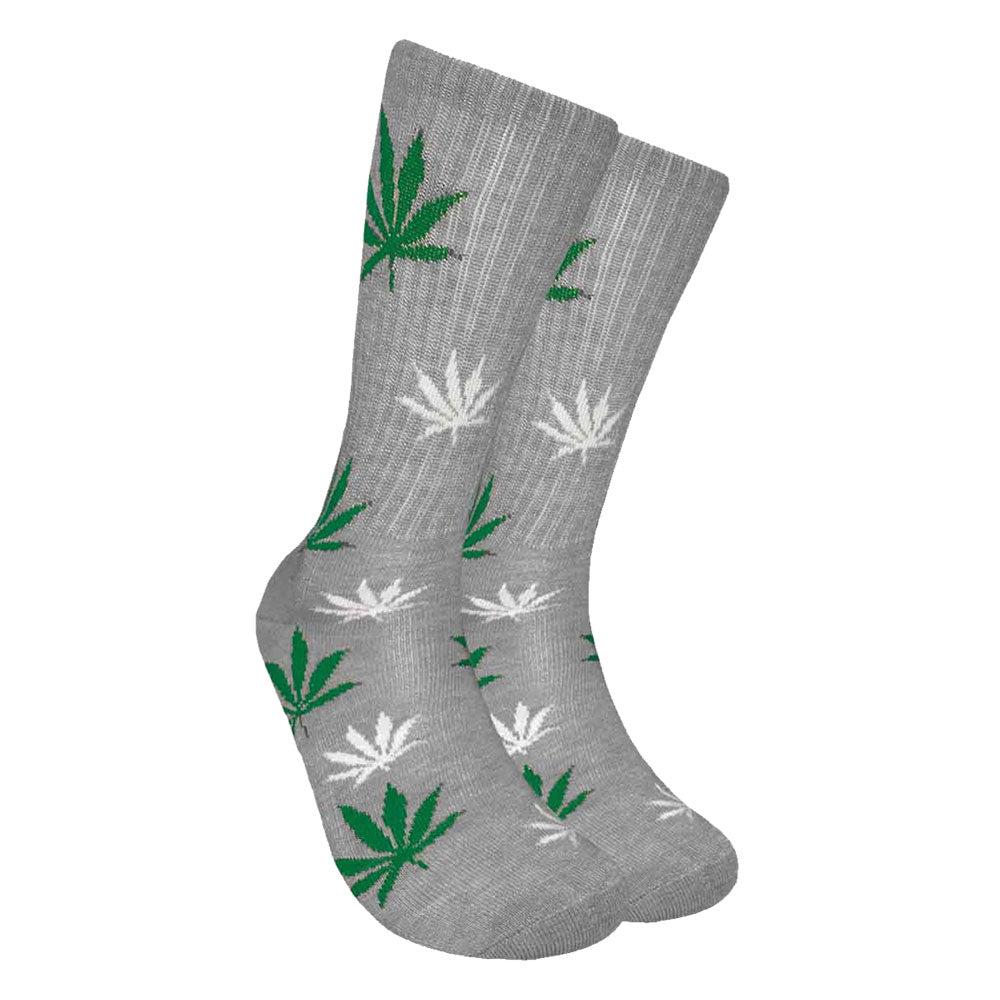 Mad Toro Socks with all-over green hemp leaf pattern on a gray background, angled view