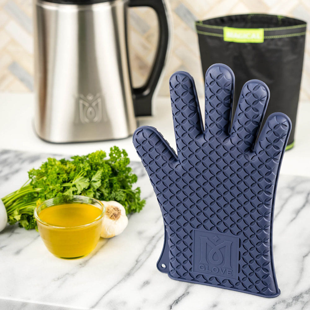 Magical Butter Silicone Glove on marble with herbs and oil, kitchen essentials