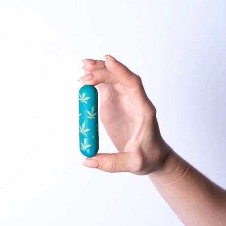 Hand holding Maia Novelties 420 Jessi Personal Massager with cannabis leaf design, 3" silicone body