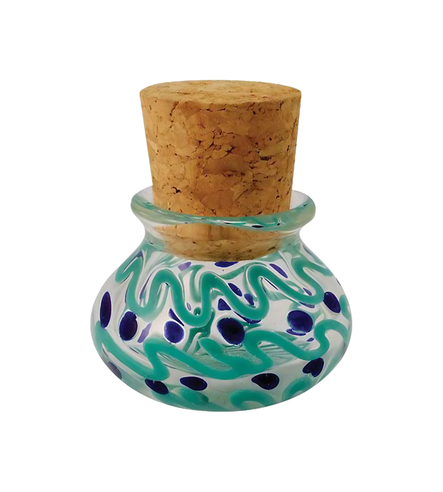 Colorful glass jar with blue squiggles and dots design, cork lid, front view on white background