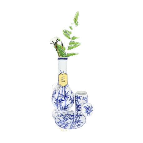 My Bud Vase "Luck" Bong in blue and white ceramic with floral design, front view with fern accessory