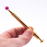 The Stash Shack Pearl Grabber Tool with pink gem, handheld view for precise dabbing