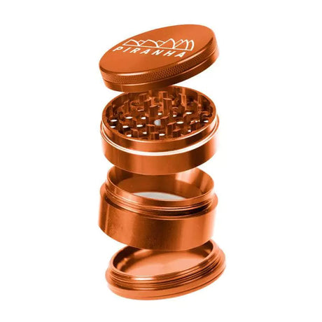 Piranha 4 Piece Aluminum Grinder, 2.5" Diameter, in Orange, Angled View with Visible Compartments