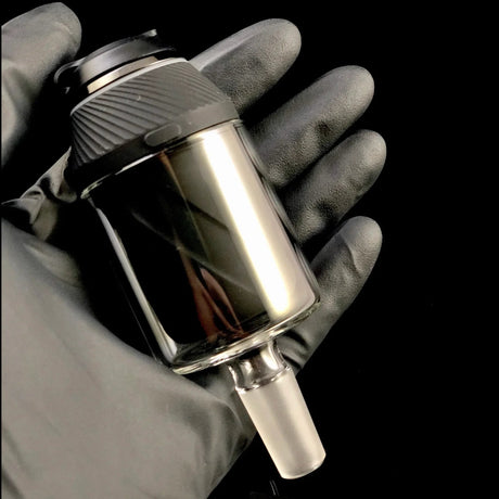 The Stash Shack Proxy Glass Adapter for concentrates, held in hand, angled view