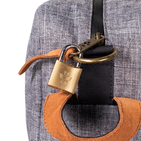 Close-up of Revelry The Stowaway Smell Proof Toiletry Bag with lock and logo