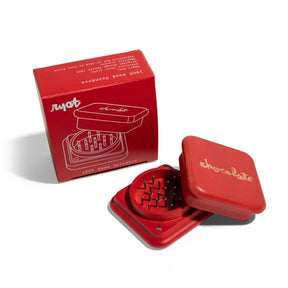 RYOT x Chocolate 2 Piece Red Maple Grinder with Steel Teeth, Open View Next to Box