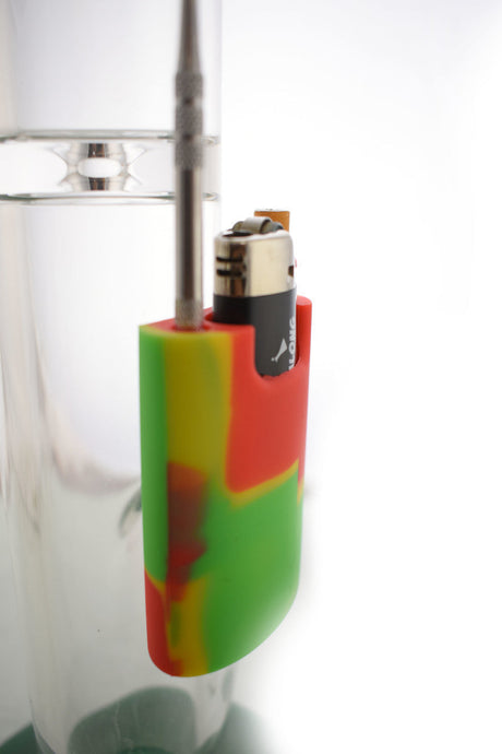 Assorted colors silicone lighter and dab tool station attached to a bong, side view